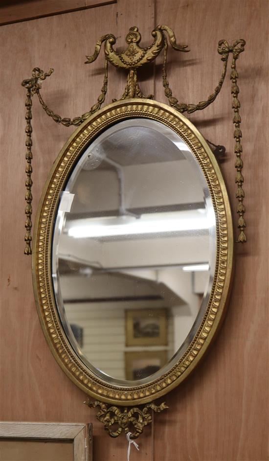 An Adam design oval giltwood and gesso wall mirror H.70cm (a.f.)